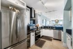 Dark cabinetry and granite counters highlighted by stainless appliances